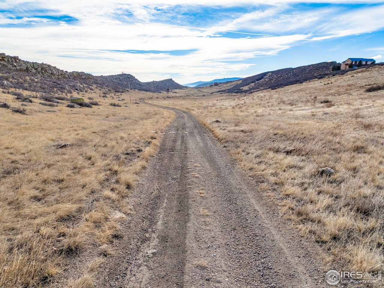 7805 Arapahoe Valley Road Laporte, CO 80535 - Photo 28 of 30 a view of a dry yard with mountains in the background
