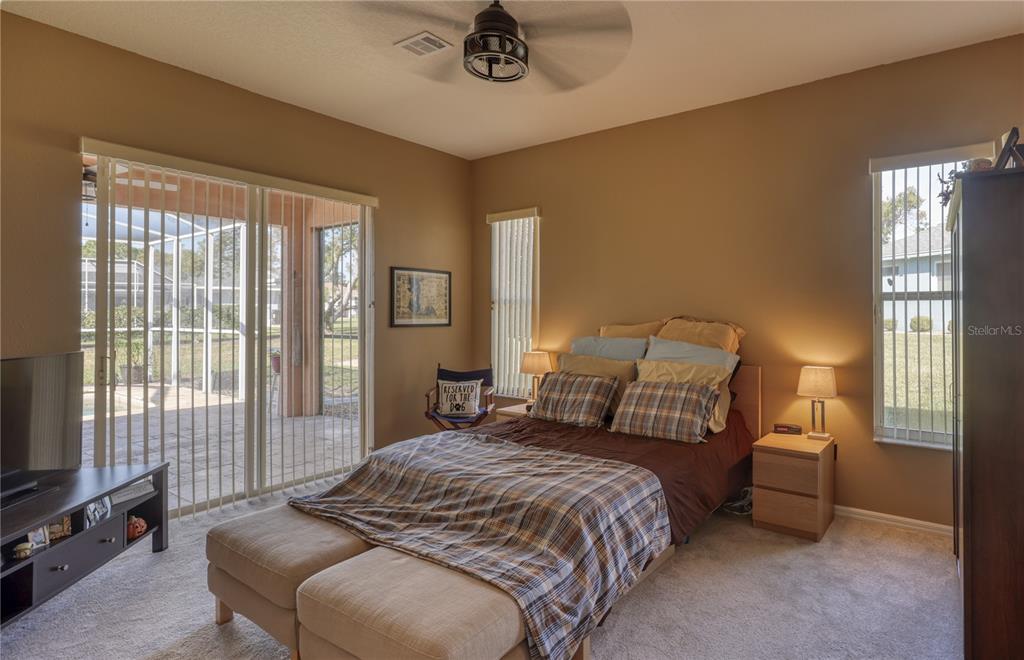 3473 Conifer Loop Spring Hill, FL 34609 - Photo 13 of 33 a bedroom with a bed a couch and dresser
