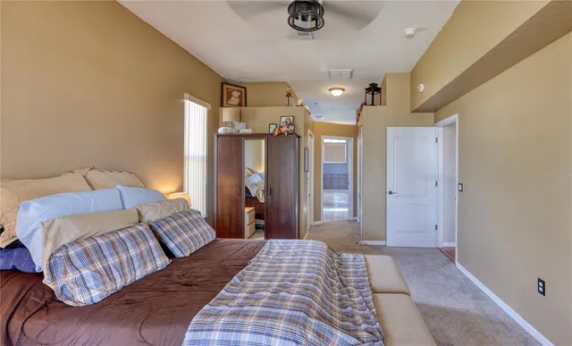 a bedroom with a large bed and a chandelier