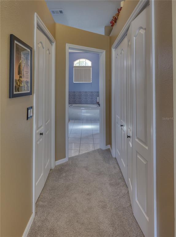3473 Conifer Loop Spring Hill, FL 34609 - Photo 15 of 33 a view of a hallway with wooden floor and closet