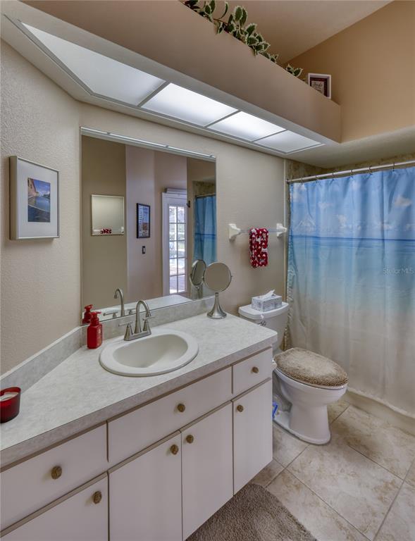 3473 Conifer Loop Spring Hill, FL 34609 - Photo 20 of 33 a bathroom with a toilet sink and mirror
