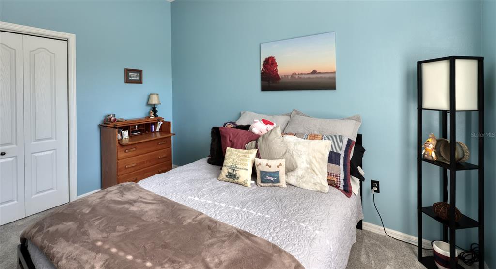 3473 Conifer Loop Spring Hill, FL 34609 - Photo 24 of 33 a bedroom with a bed and wooden floor