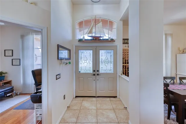 a view of a hallway with dining room and chandelier