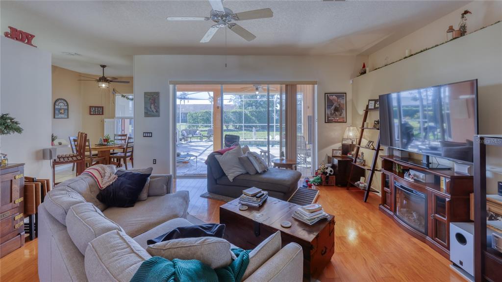 3473 Conifer Loop Spring Hill, FL 34609 - Photo 5 of 33 a living room with furniture and a floor to ceiling window
