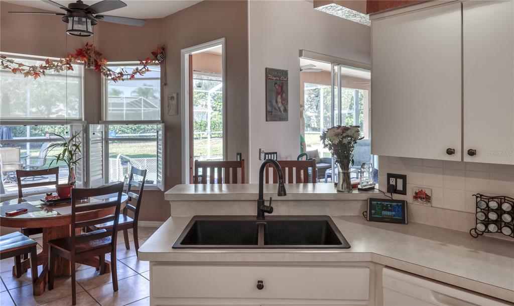 3473 Conifer Loop Spring Hill, FL 34609 - Photo 10 of 33 a kitchen view with a table and chairs