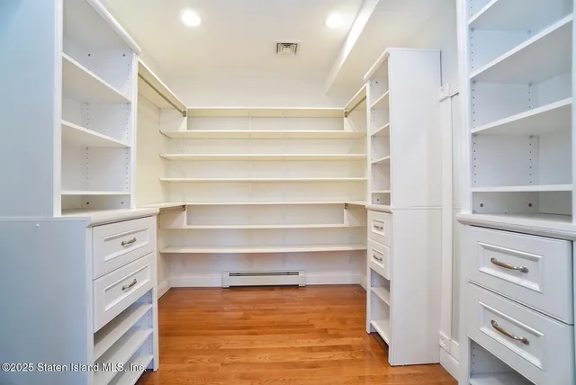 a view of walk in closet with empty racks