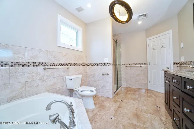 a bathroom with a sink a toilet and a shower