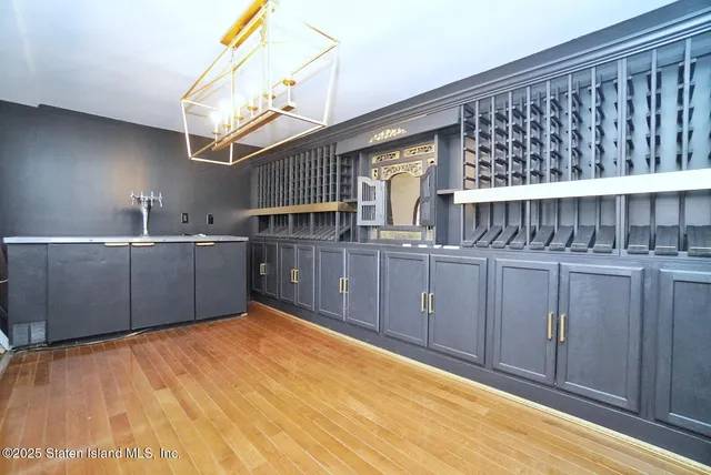 a view of a kitchen with furniture and wooden floor
