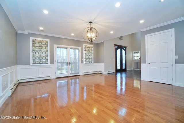 a view of an entryway with wooden floor