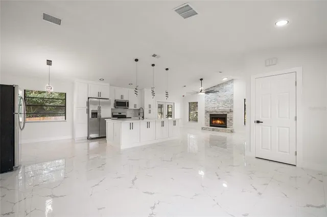 a view of kitchen with refrigerator and window