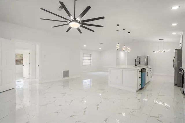 a view of a kitchen with a sink and a refrigerator
