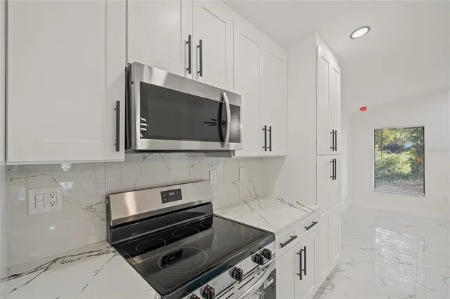 a kitchen with a stove and a microwave