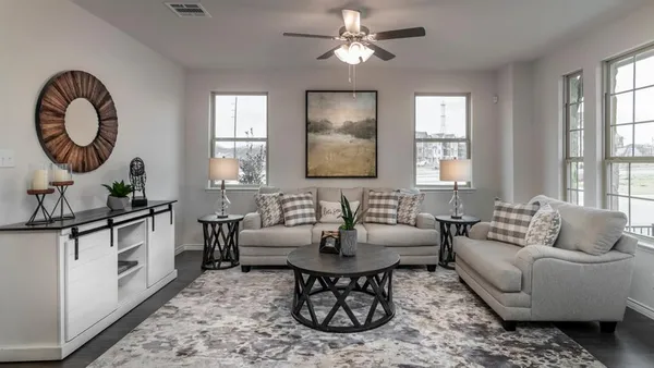 a living room with furniture a window and a chandelier
