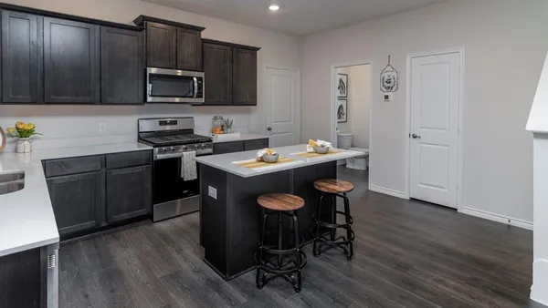 a kitchen with a sink stove and microwave