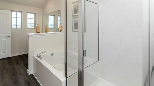 a bathroom with a bathtub and a shower