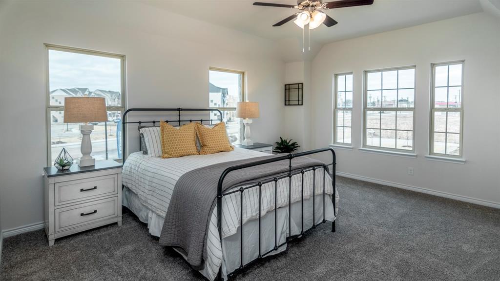 2240 Lasso Court Mesquite, TX 75149 - Photo 7 of 11 a bedroom with a bed and a chandelier