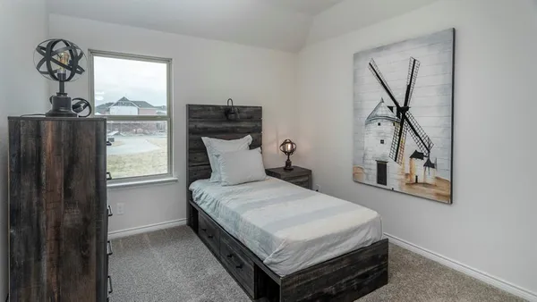 a bedroom with a bed and window