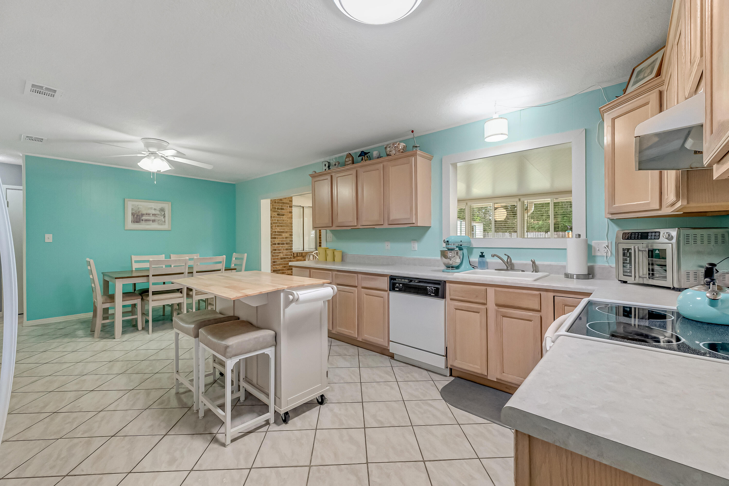 1811 Rattan Palm Drive Niceville, FL 32578 - Photo 11 of 57 a kitchen with stainless steel appliances granite countertop a stove top oven a sink dishwasher and cabinets