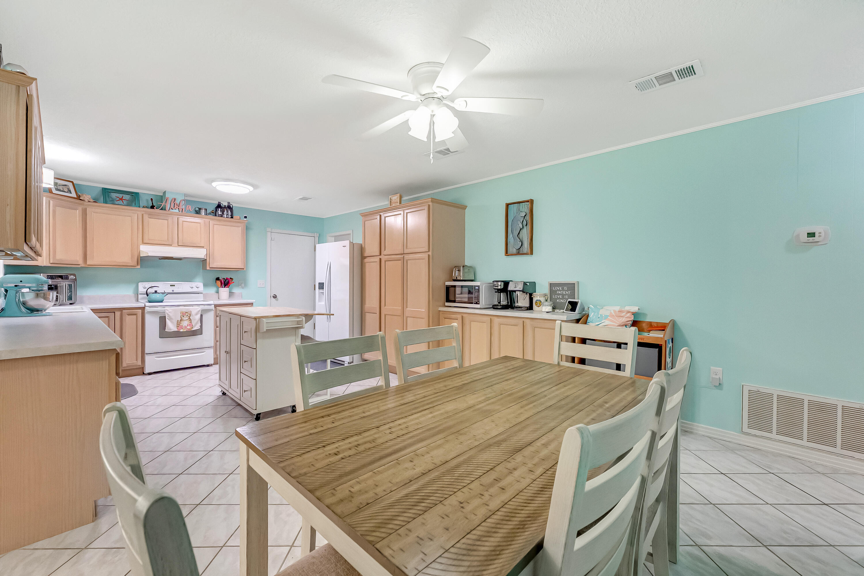 1811 Rattan Palm Drive Niceville, FL 32578 - Photo 17 of 57 a room with stainless steel appliances kitchen island granite countertop a dining table chairs and a refrigerator