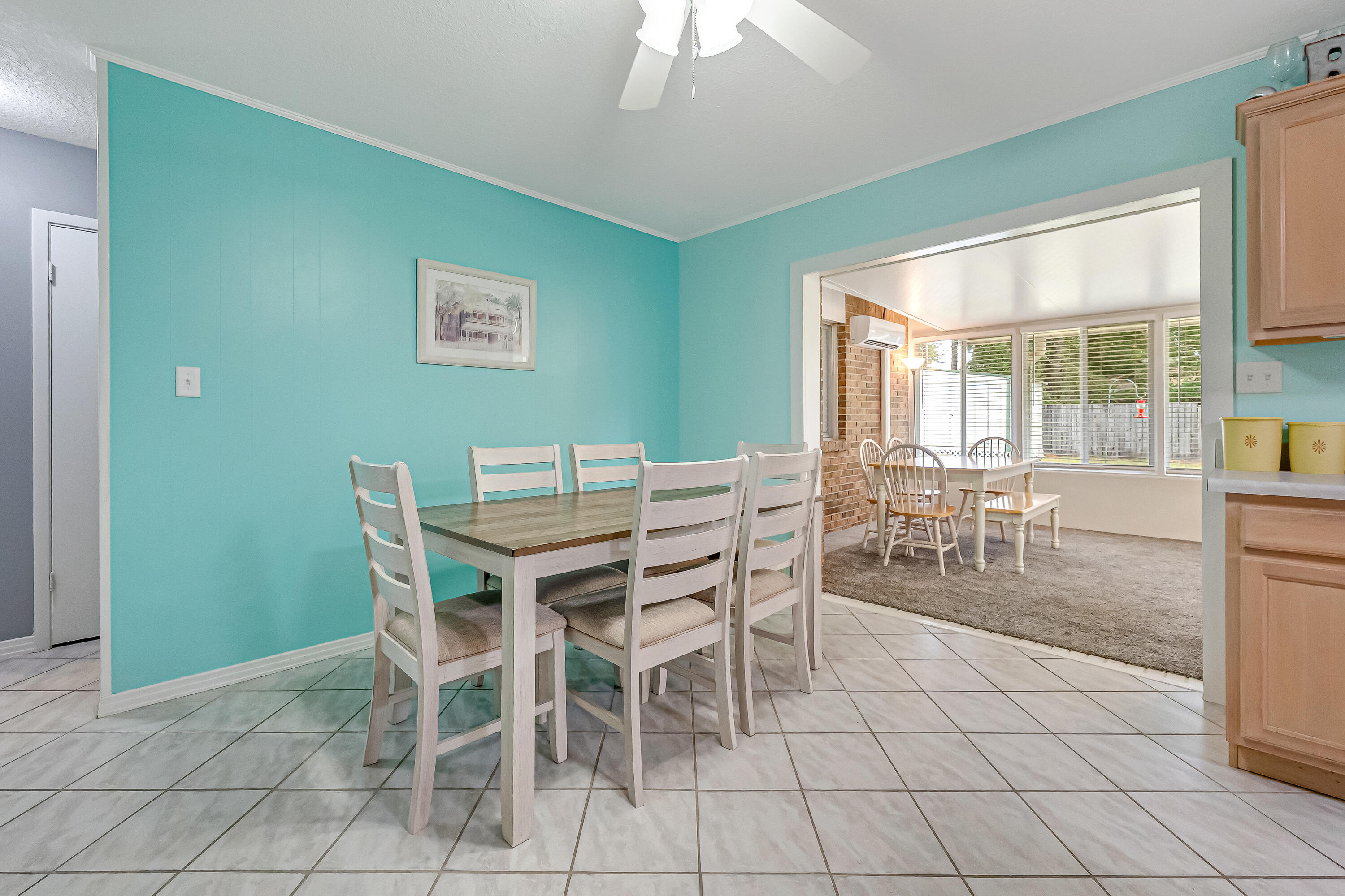 1811 Rattan Palm Drive Niceville, FL 32578 - Photo 21 of 57 a dining room with furniture a rug and a large window
