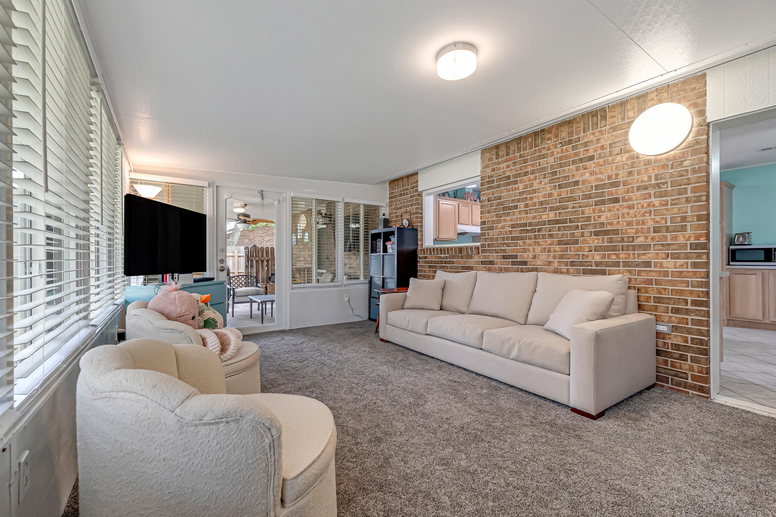 1811 Rattan Palm Drive Niceville, FL 32578 - Photo 25 of 57 a living room with furniture and a flat screen tv