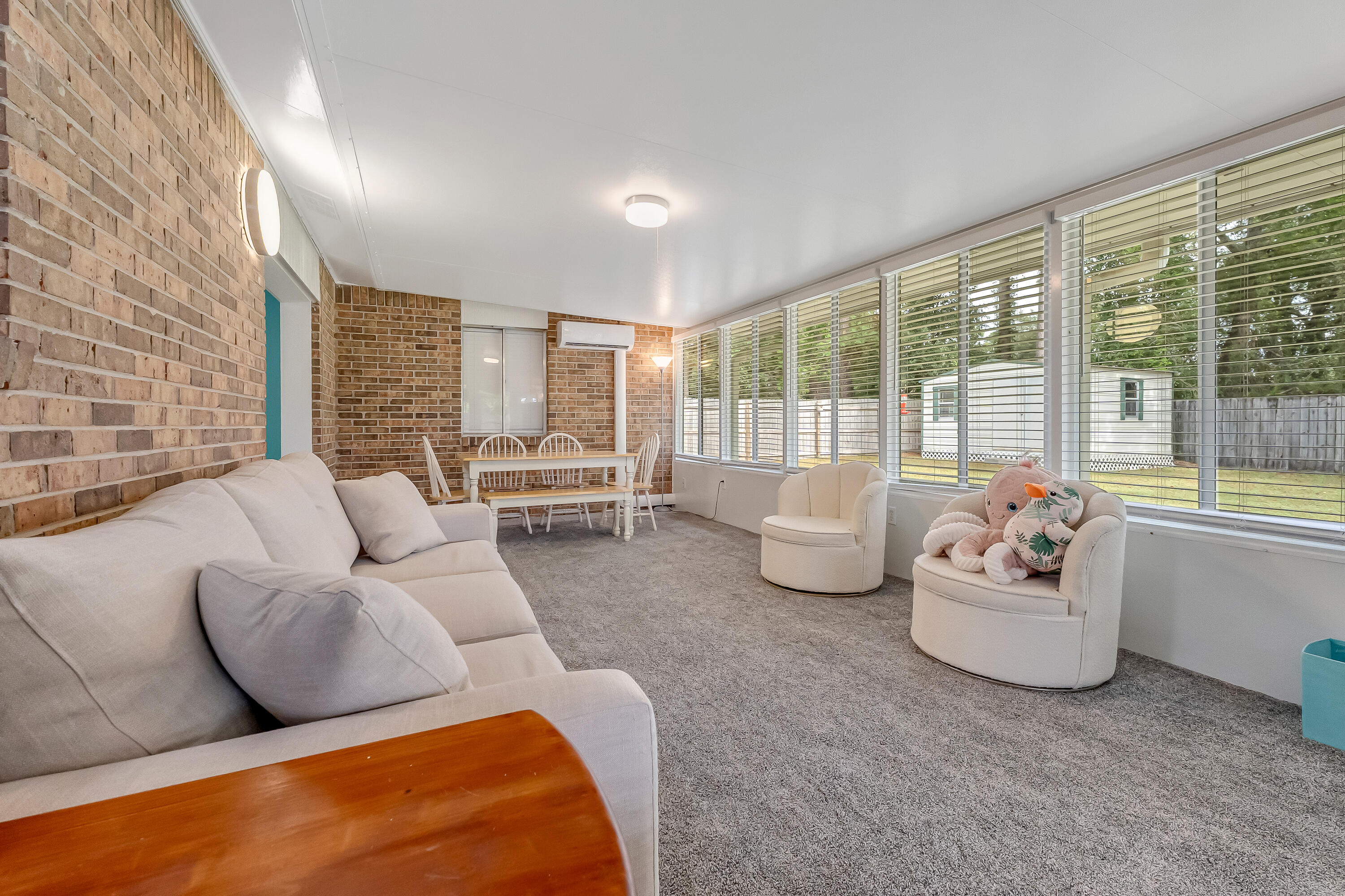 1811 Rattan Palm Drive Niceville, FL 32578 - Photo 27 of 57 a living room with furniture and large windows