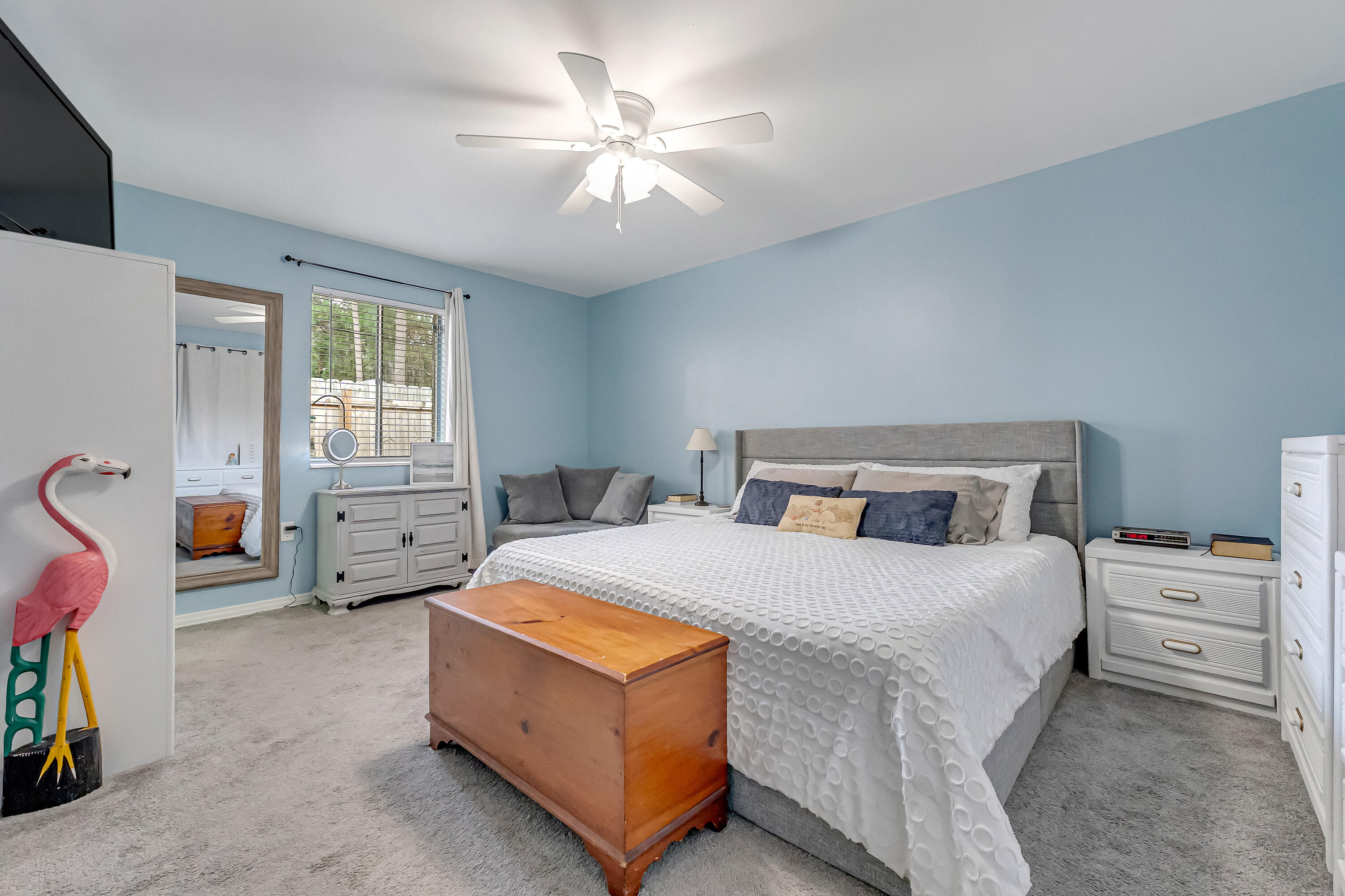 1811 Rattan Palm Drive Niceville, FL 32578 - Photo 28 of 57 a bedroom with a bed a chandelier and a chair