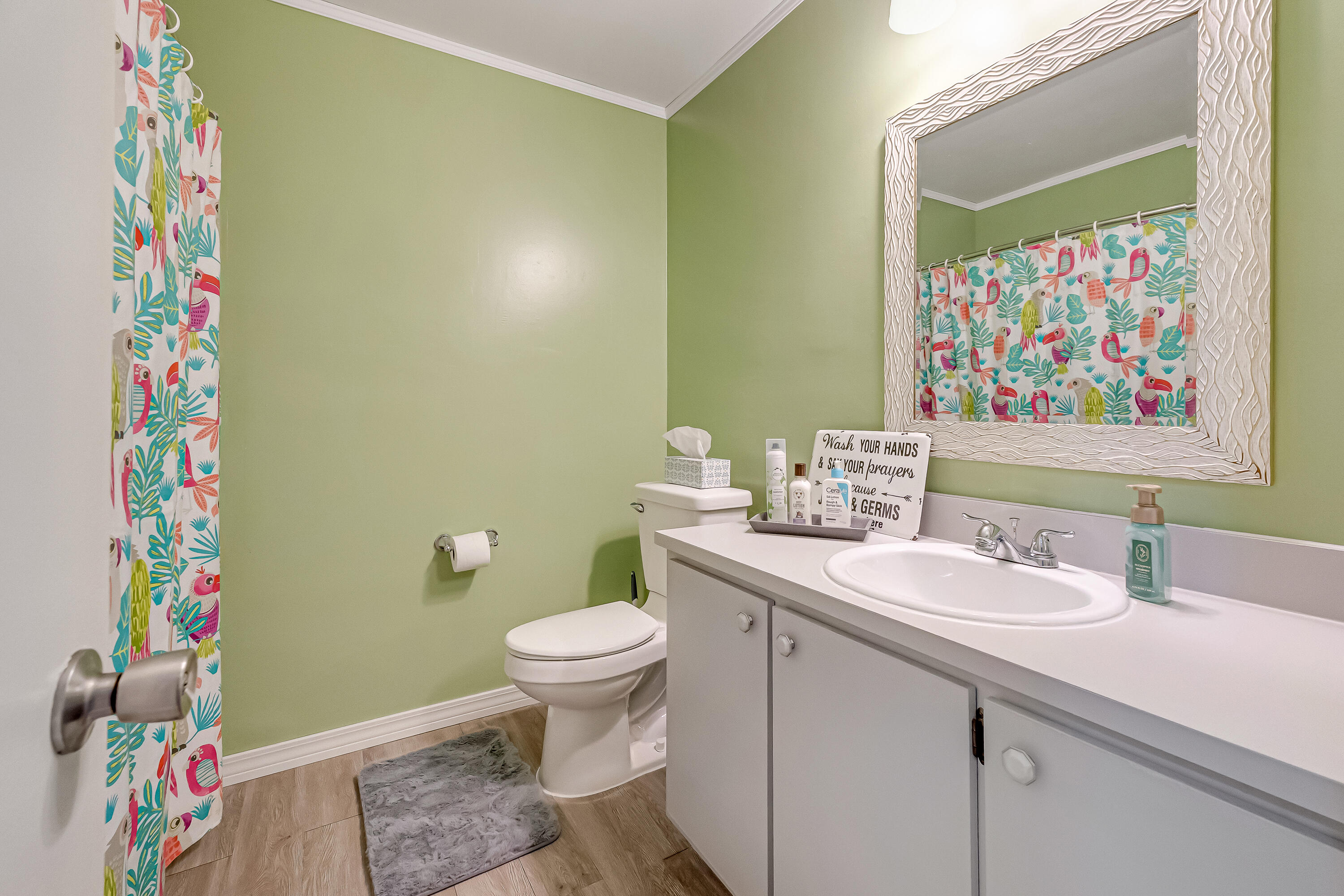 1811 Rattan Palm Drive Niceville, FL 32578 - Photo 37 of 57 a bathroom with a sink a toilet and shower curtain