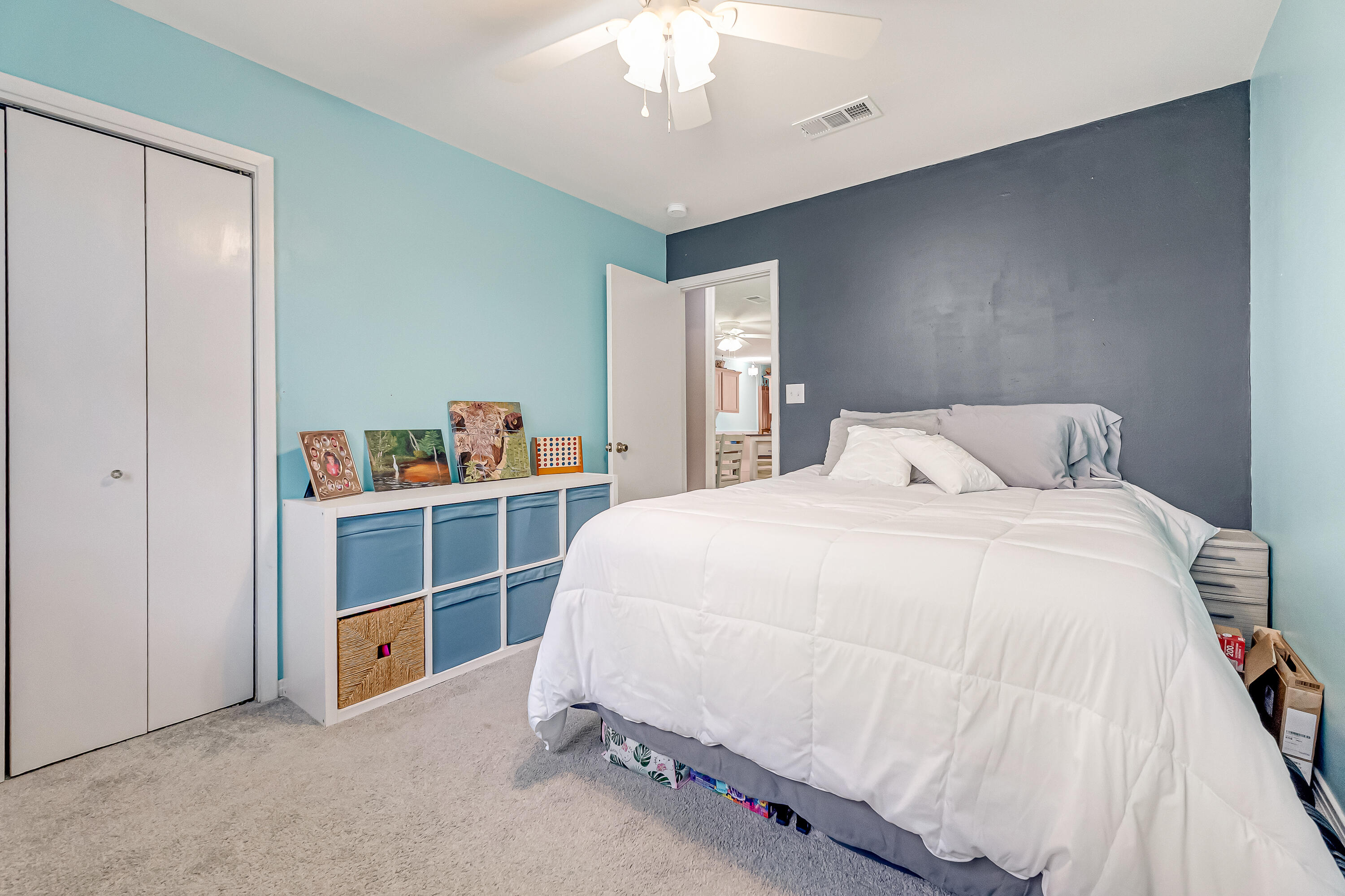 1811 Rattan Palm Drive Niceville, FL 32578 - Photo 41 of 57 a spacious bedroom with a bed and a chandelier