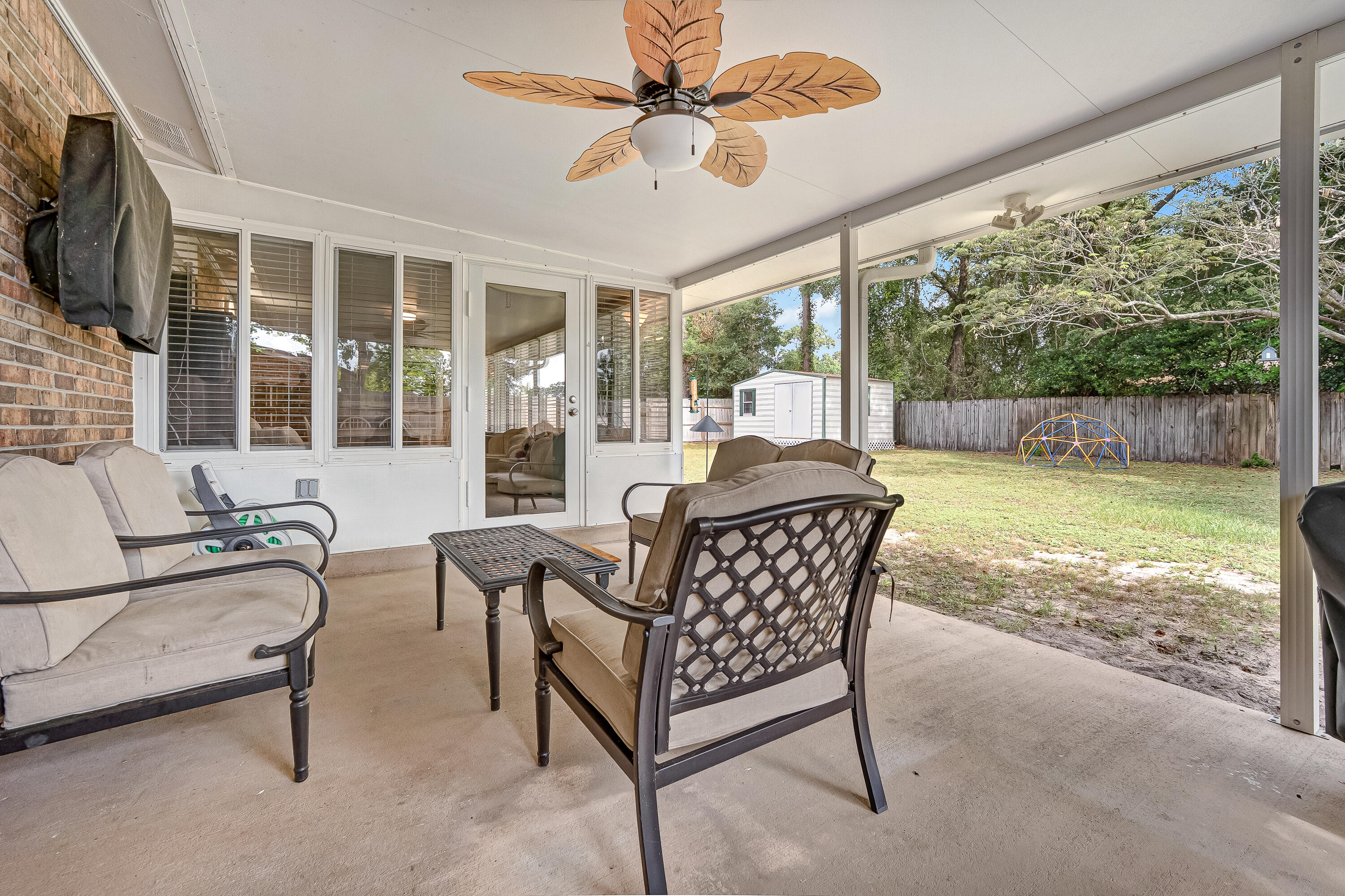 1811 Rattan Palm Drive Niceville, FL 32578 - Photo 43 of 57 a living room with patio furniture and a large window