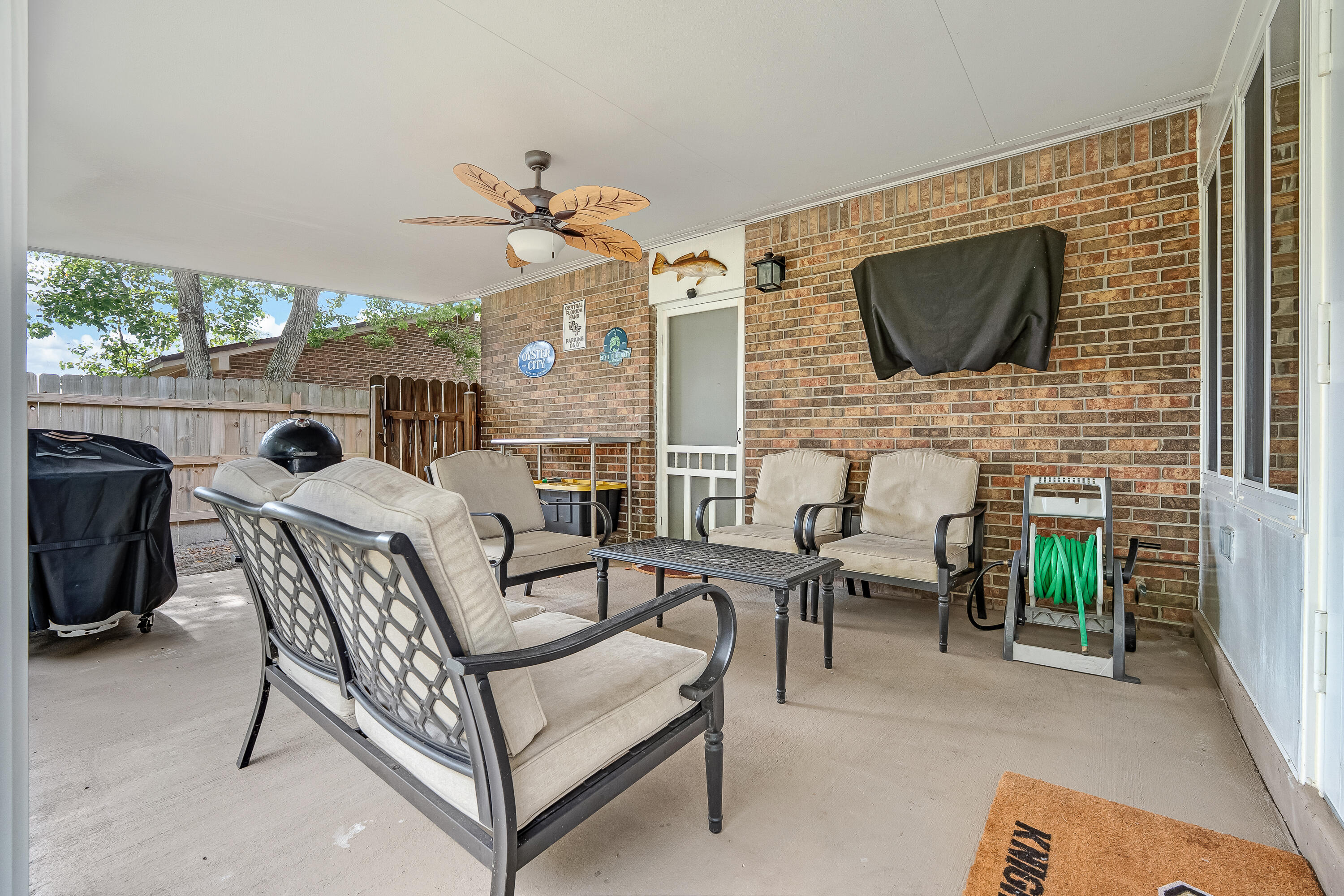 1811 Rattan Palm Drive Niceville, FL 32578 - Photo 45 of 57 a living room with furniture a flat screen tv and a fireplace
