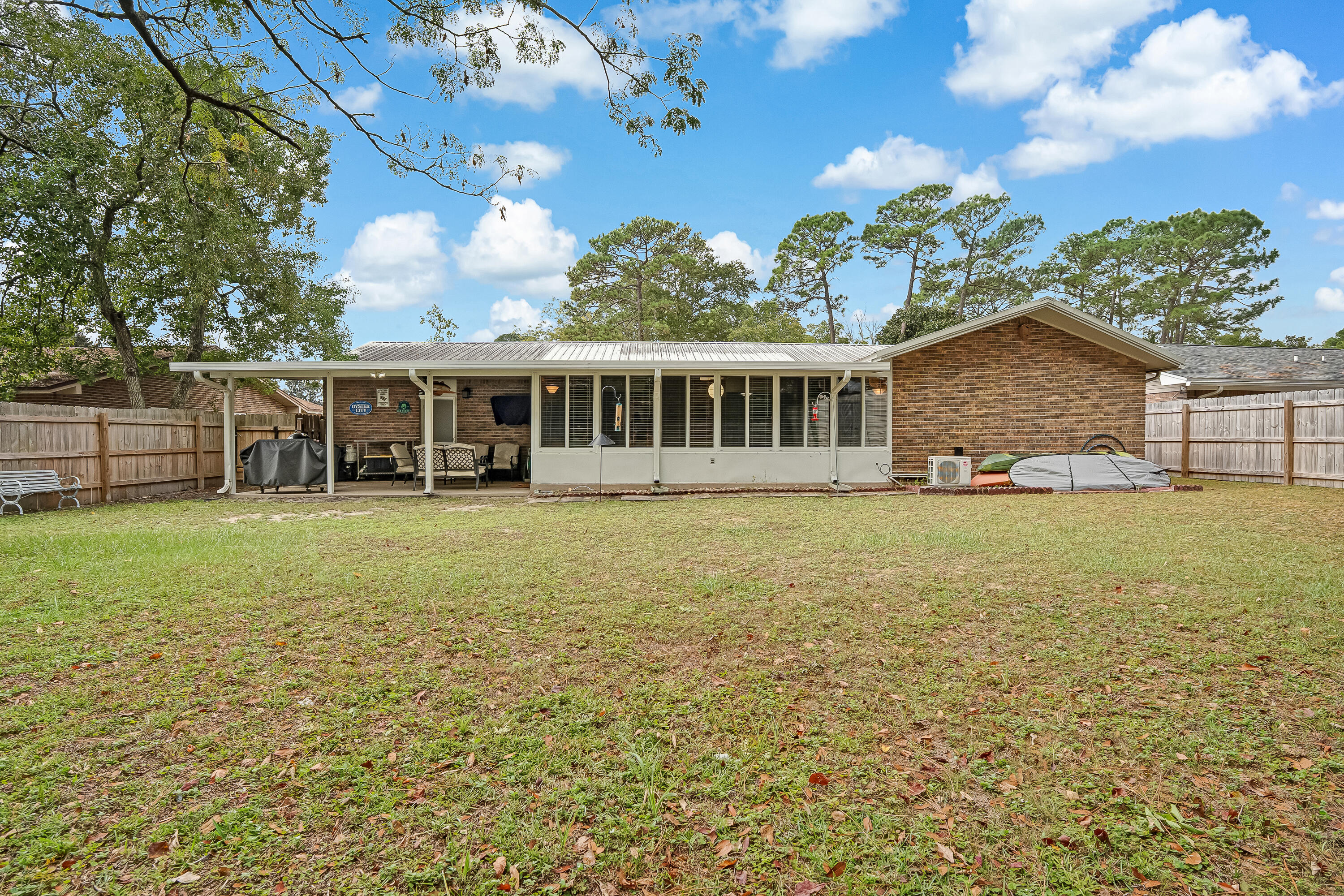 1811 Rattan Palm Drive Niceville, FL 32578 - Photo 48 of 57 a view of a house with a garden and trees