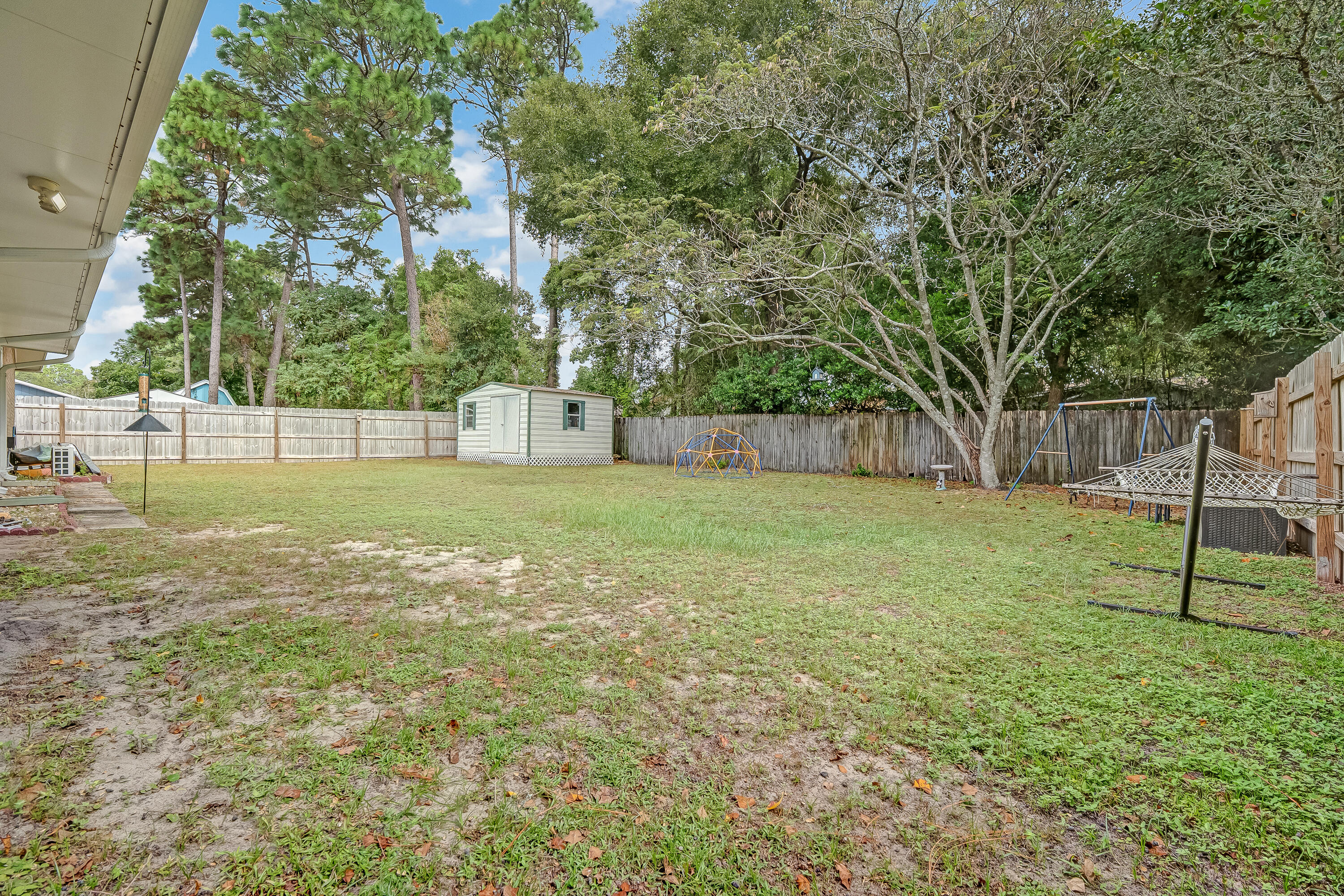 1811 Rattan Palm Drive Niceville, FL 32578 - Photo 49 of 57 a view of a backyard with a garden