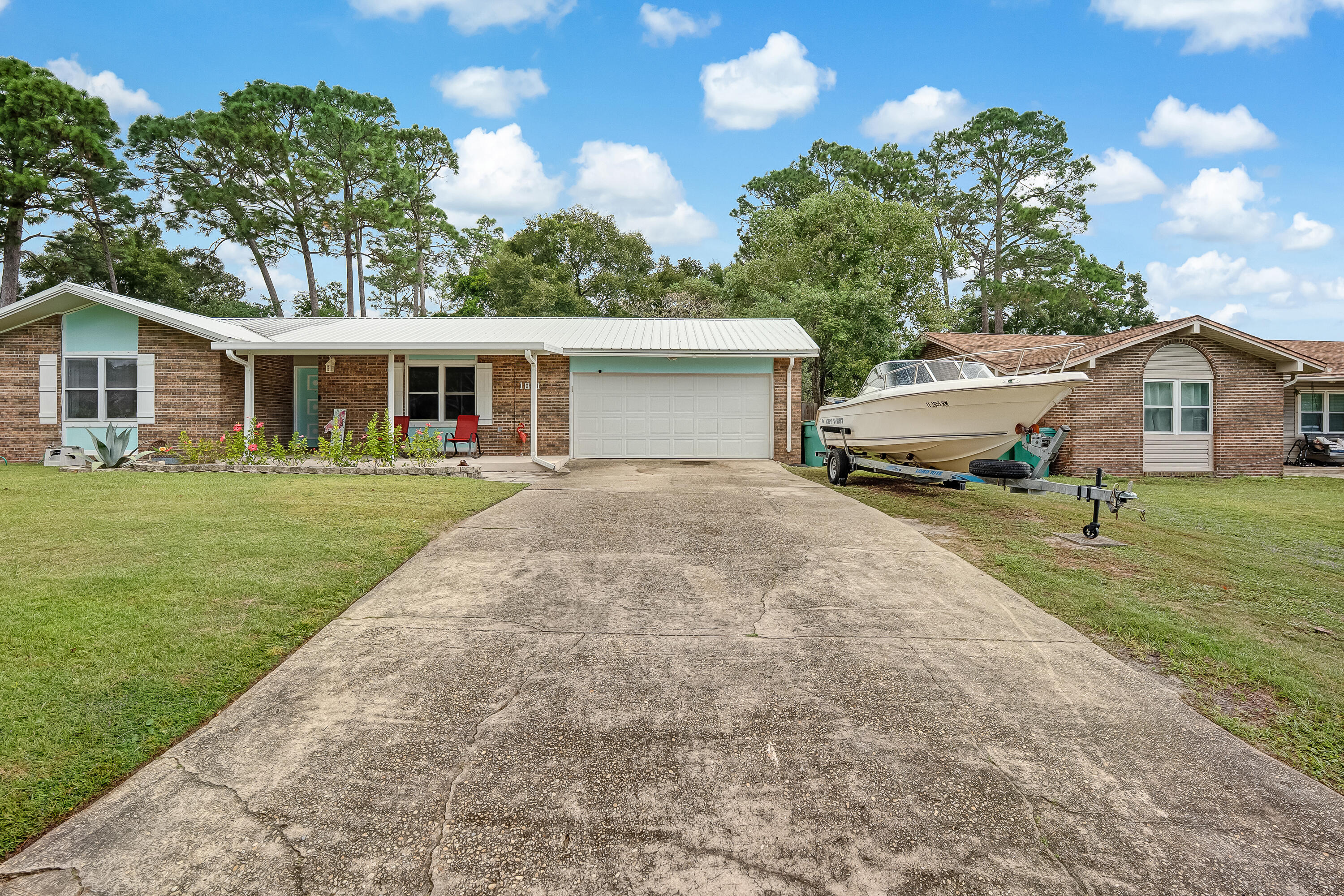 1811 Rattan Palm Drive Niceville, FL 32578 - Photo 56 of 57 a front view of a house with a garden and trees