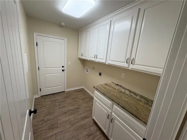 a kitchen with granite countertop a sink and a stove