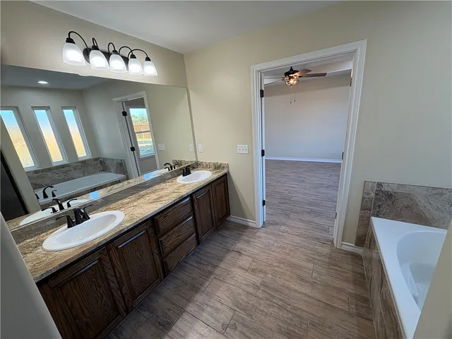 a bathroom with a double vanity sink and a mirror