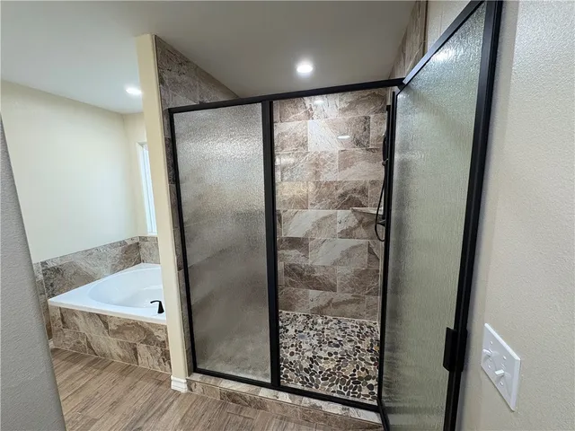 a bathroom with a glass shower door and a sink