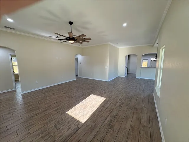a view of a livingroom with a hall and wooden floor