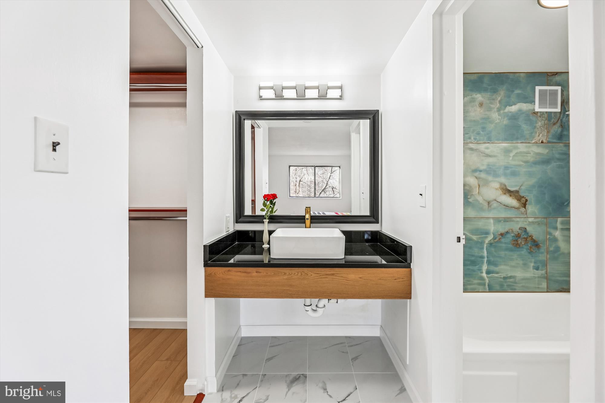 1836 Metzerott Road, Unit T3 Hyattsville, MD 20783 - Photo 16 of 28 a bathroom with a sink a mirror and a bathtub