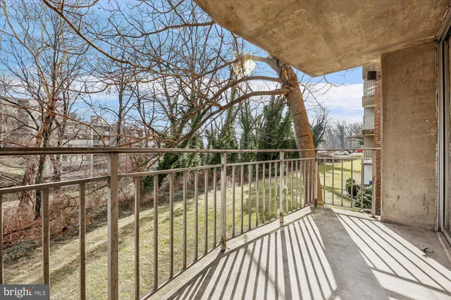 a view of balcony with wooden floor and fence