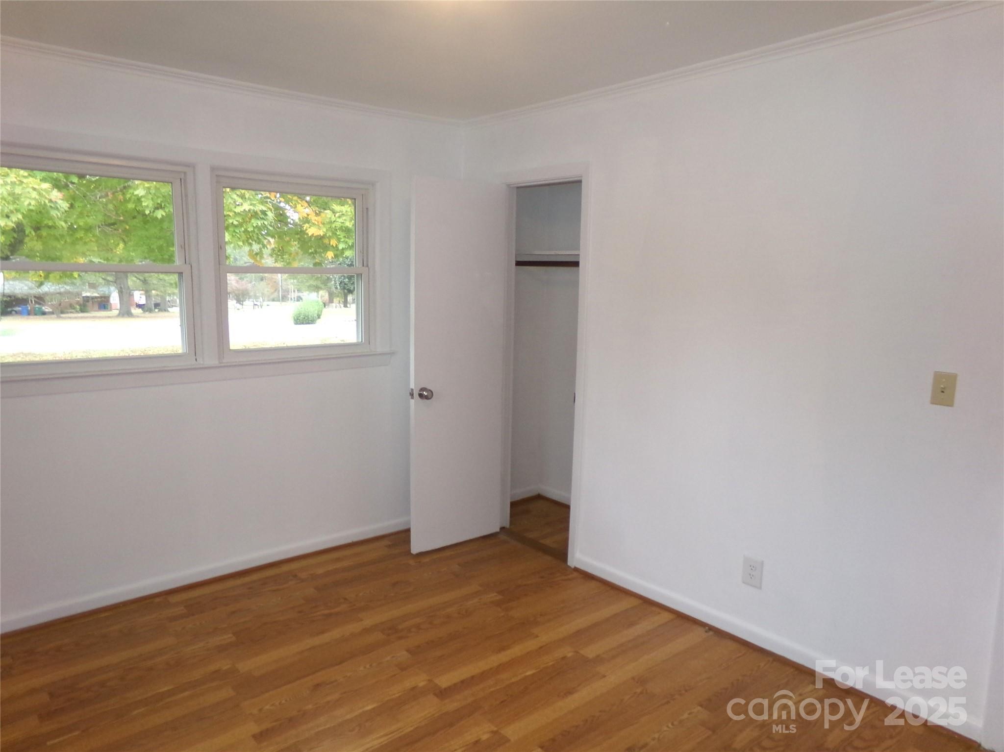 801 Anderson Road Albemarle, NC 28001 - Photo 15 of 23 an empty room with wooden floor and windows