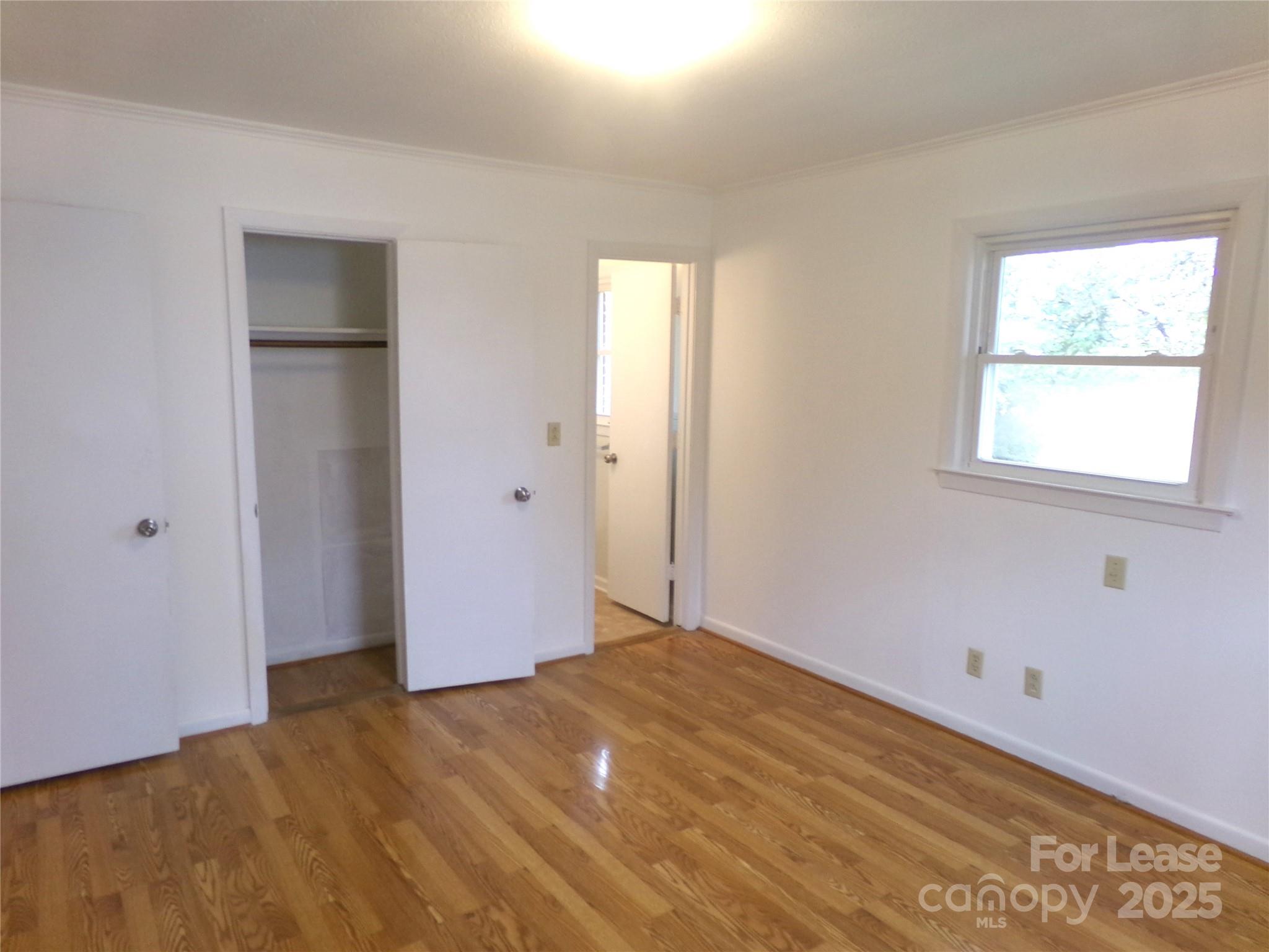 801 Anderson Road Albemarle, NC 28001 - Photo 18 of 23 a view of an empty room with wooden floor and a window