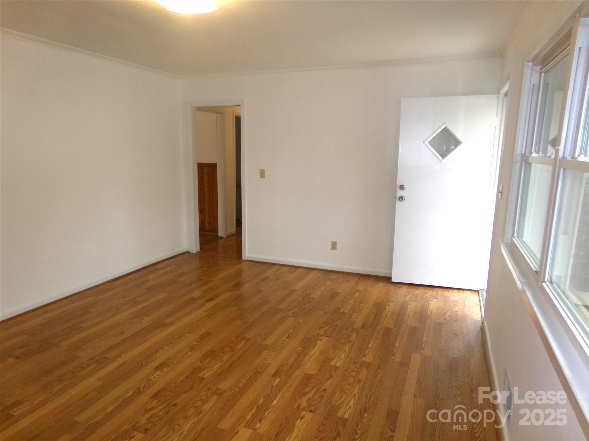 801 Anderson Road Albemarle, NC 28001 - Photo 5 of 23 a view of an empty room with wooden floor and a window
