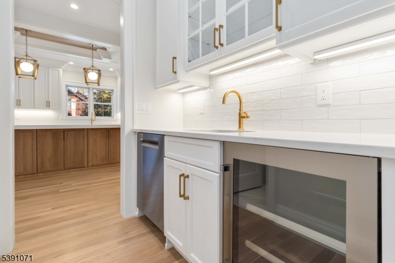 2 Whitman Drive Chatham, NJ 07928 - Photo 11 of 50 a kitchen with a sink cabinets and a wooden floor