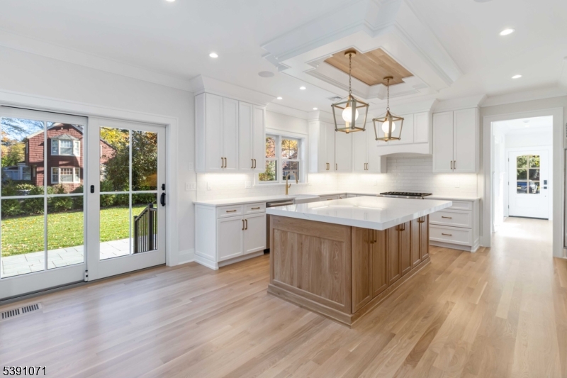2 Whitman Drive Chatham, NJ 07928 - Photo 13 of 50 a view of kitchen with granite countertop a stove top oven a sink and wooden floors