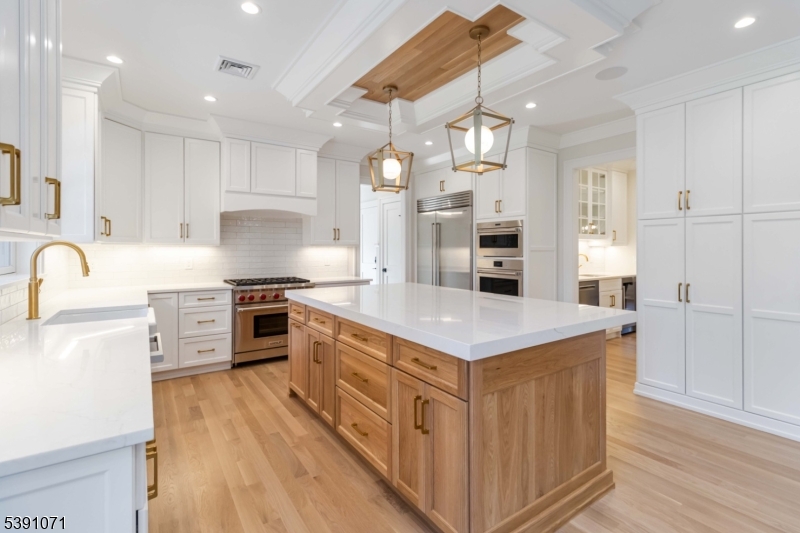 2 Whitman Drive Chatham, NJ 07928 - Photo 14 of 50 a kitchen with stainless steel appliances granite countertop a stove top oven a sink dishwasher and a refrigerator with wooden floor