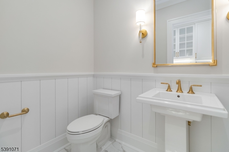 2 Whitman Drive Chatham, NJ 07928 - Photo 19 of 50 a bathroom with a sink a toilet and a mirror