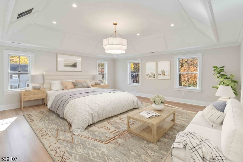 2 Whitman Drive Chatham, NJ 07928 - Photo 23 of 50 a spacious bedroom with a bed and a chandelier