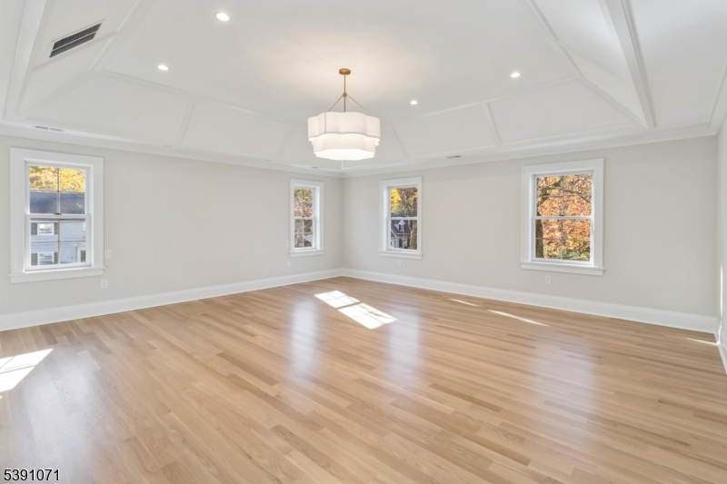 2 Whitman Drive Chatham, NJ 07928 - Photo 24 of 50 an empty room with wooden floor and windows