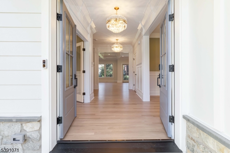 2 Whitman Drive Chatham, NJ 07928 - Photo 3 of 50 a view of a hallway view with wooden floor and staircase
